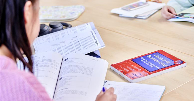 A student reading through textbooks